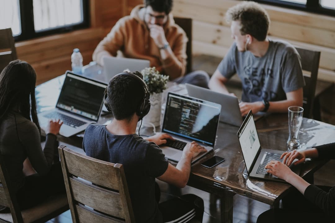 Software engineering team collaborating on code in a modern workspace