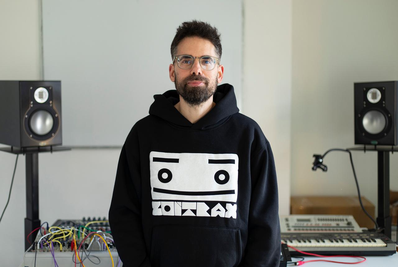 Electronic music producer working in a home studio