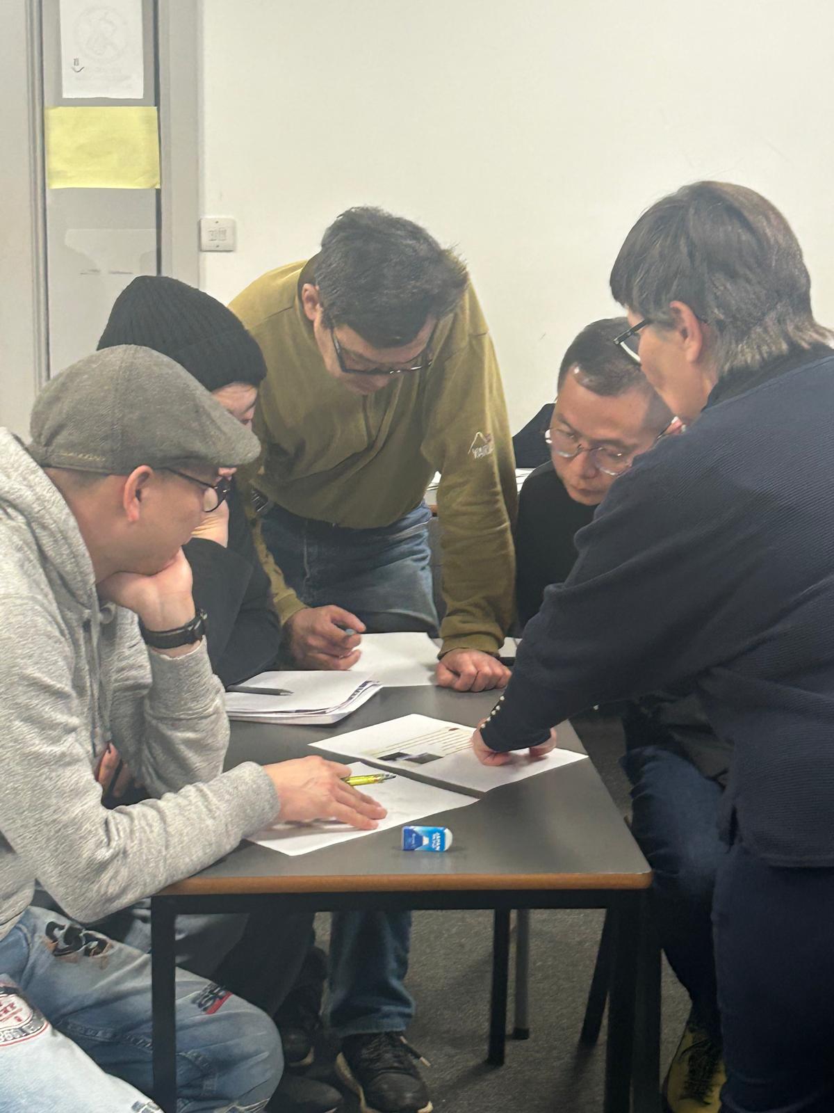 A teacher helping an adult English learner