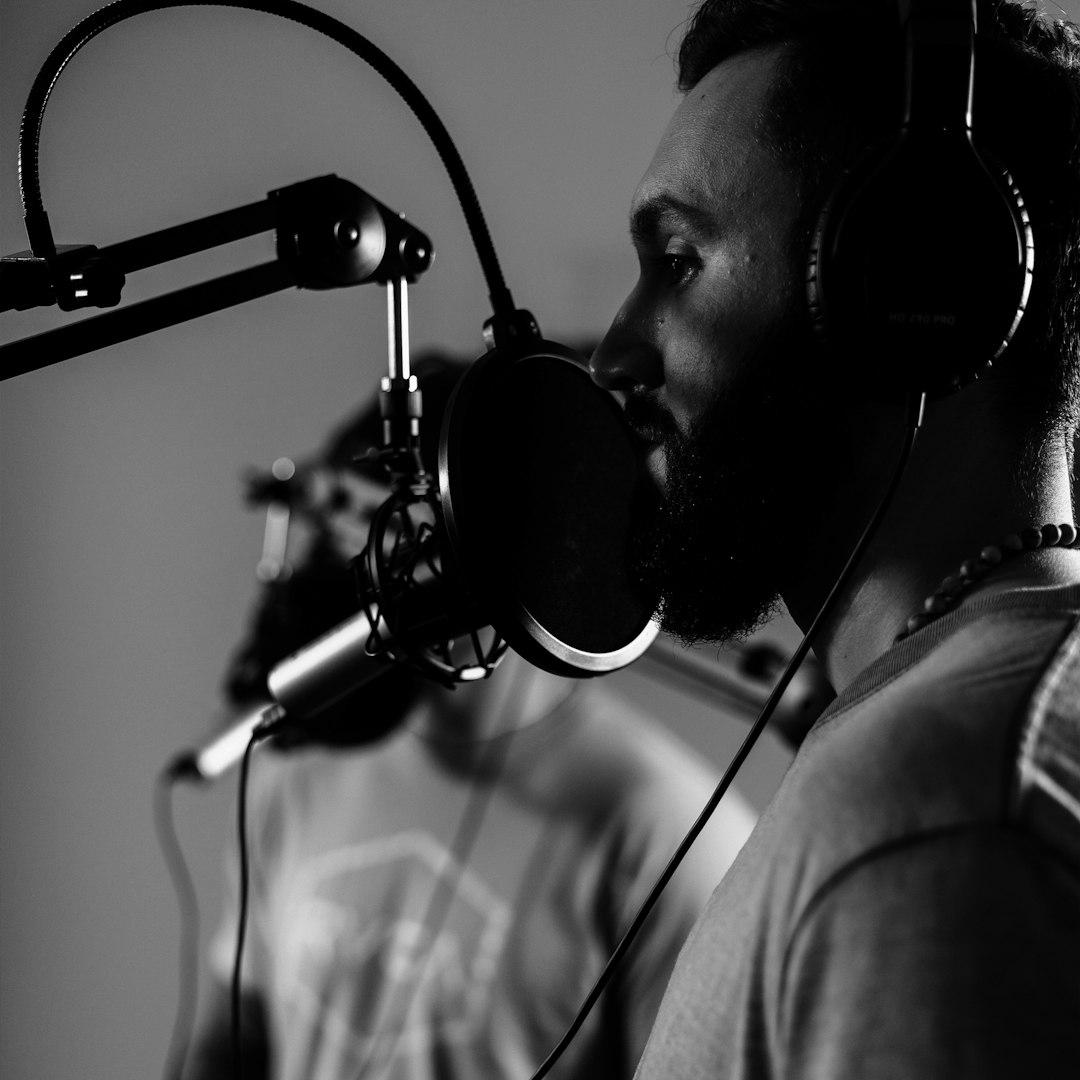 A voice-over artist recording at a microphone