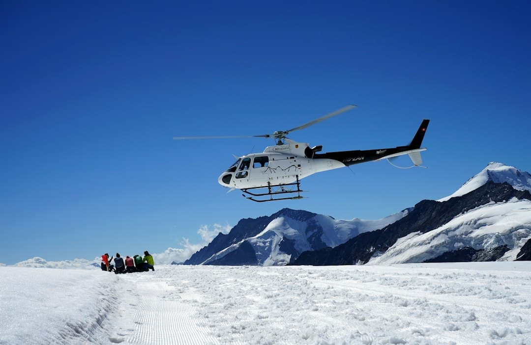 A helicopter landing in snowy mountains