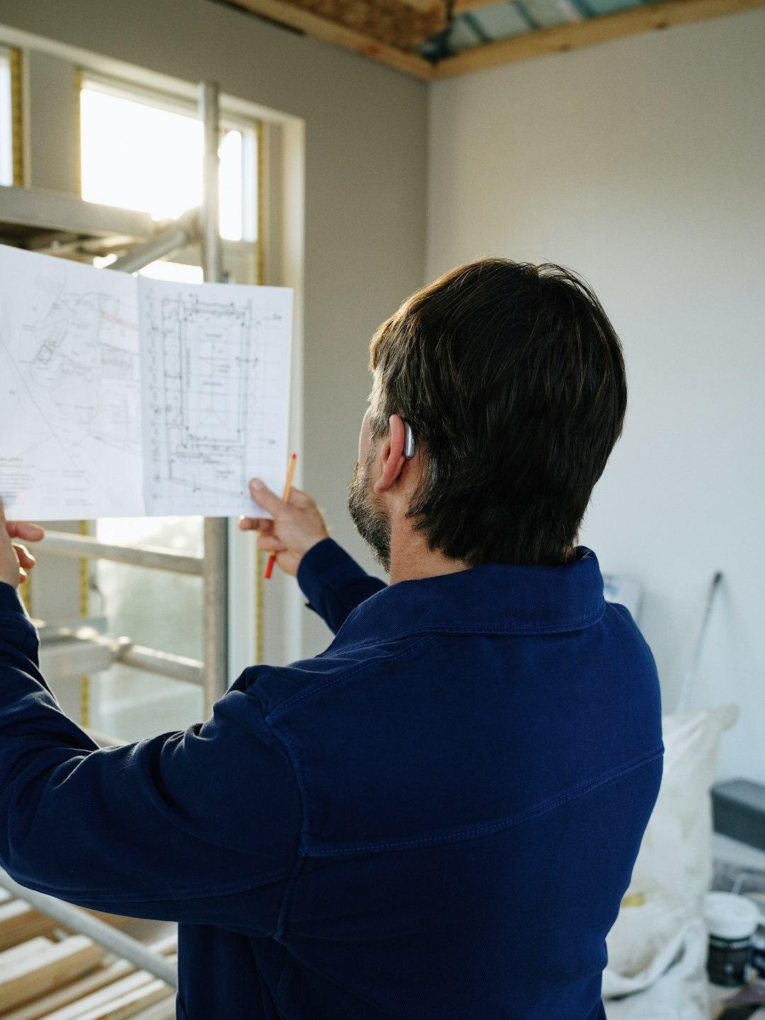 A business owner pausing to reflect over a notebook