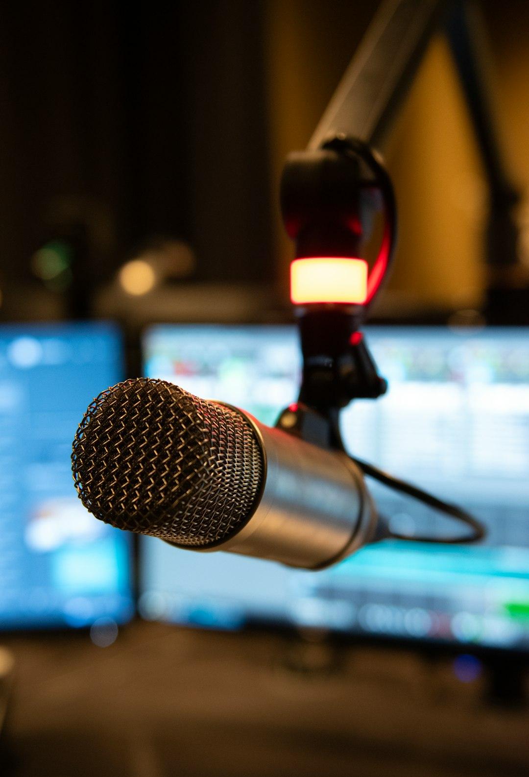 A presenter at a radio station microphone
