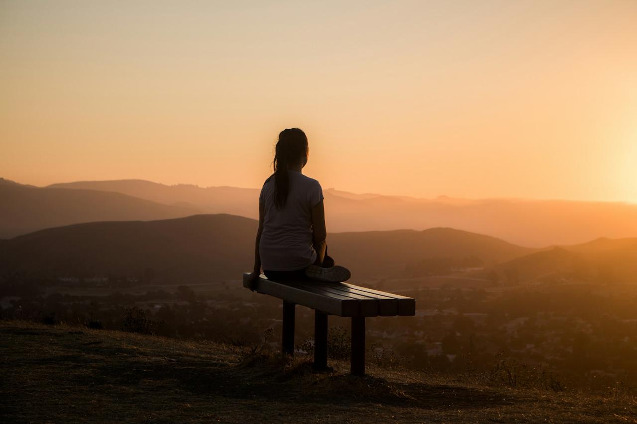 A woman sitting calmly in soft morning light