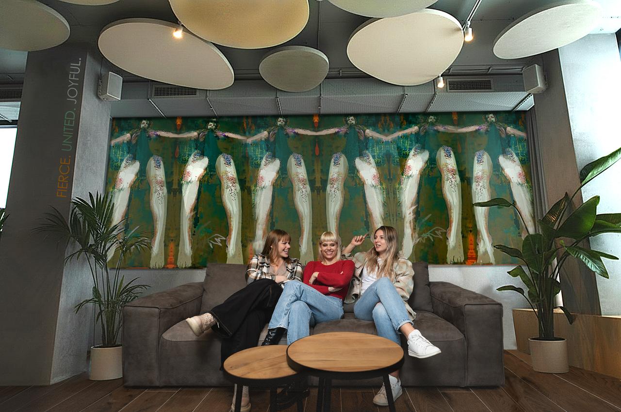 An artist adding a painted mural to a boutique interior
