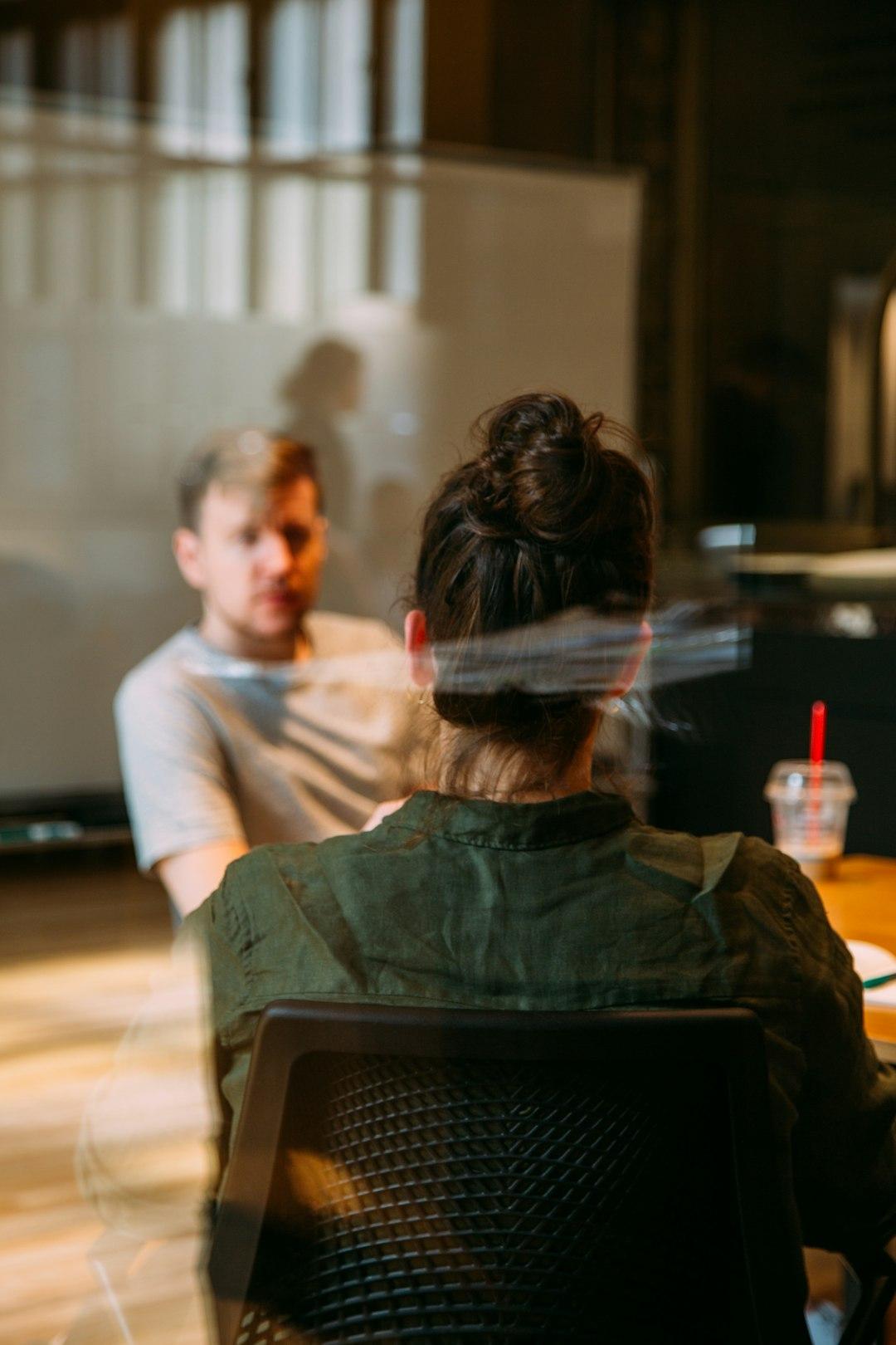 A manager in a supportive one-to-one conversation with a team member