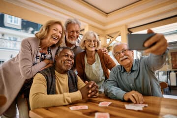 Seniors enjoying retirement and taking picture selfies