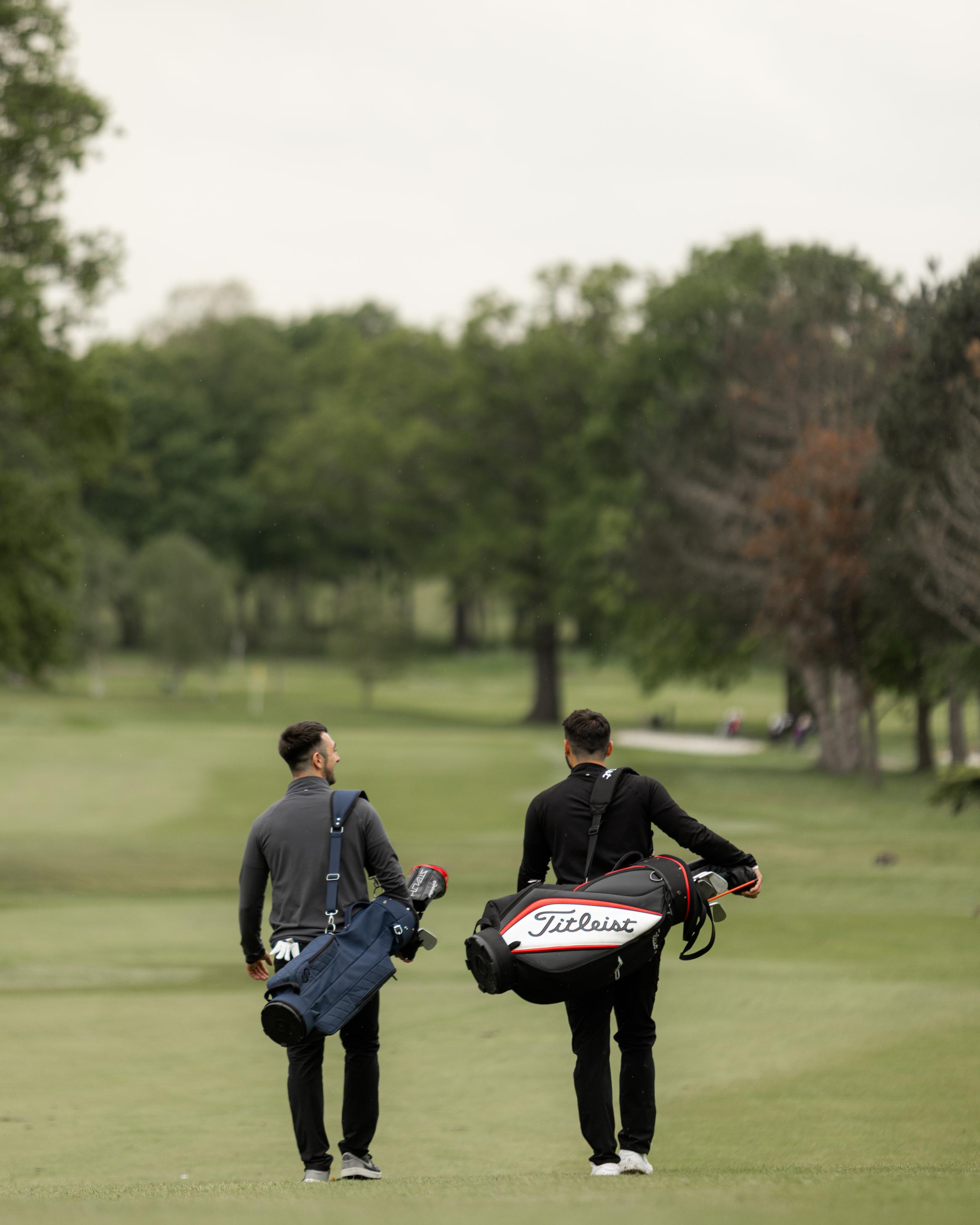 Two golfers walking the fairway