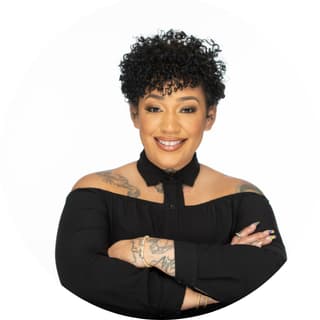 Headshot of Julisa Anderson, salon owner and entrepreneur, smiling in a professional portrait.
