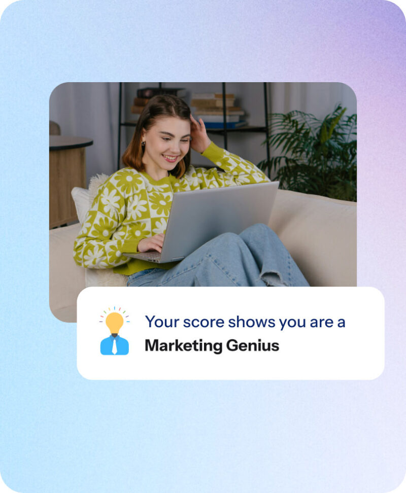 Woman smiling at laptop on sofa with a quiz result card reading 'Your score shows you are a Marketing Genius