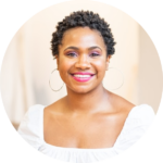 Smiling woman with short natural hair, hoop earrings, and a white top, featured on the ScoreApp Partner Program page.