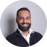 Smiling man with a beard wearing a dark zip-up jacket, ScoreApp partner program team member headshot.