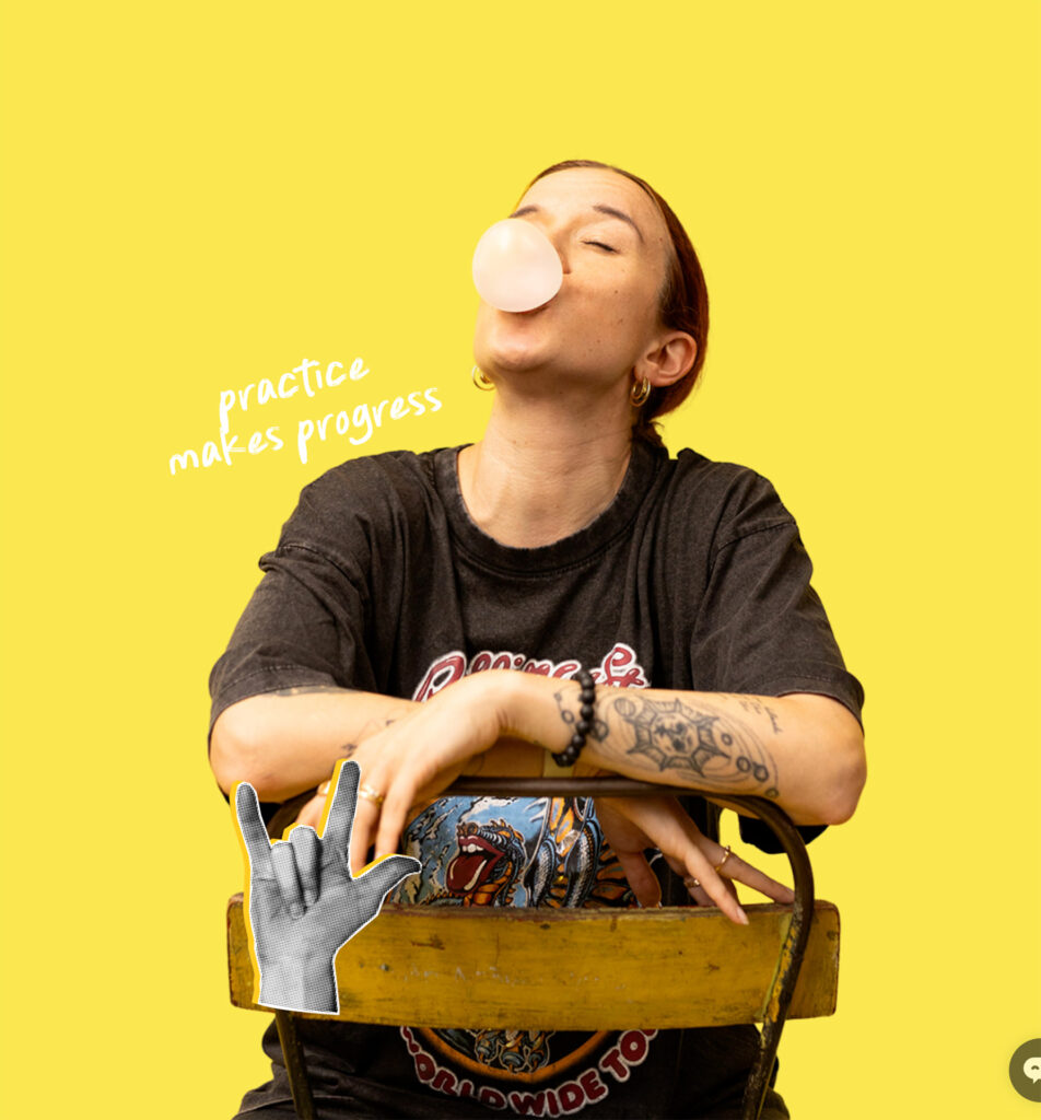 Person blowing a bubblegum bubble while seated, with text reading 'practice makes progress' on a yellow background